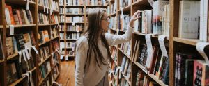 a college student browsing through a library