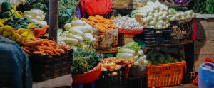 vegetables stacked in crates and baskets