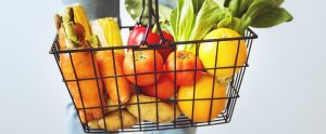 a shopping basket full of fresh fruit and vegetables