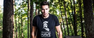 a man with a strong physique in the woods