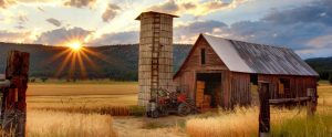a barn and a tractor in the countryside