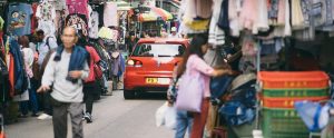 a car driving down an Asian shopping street