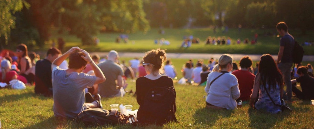 crowds of people sitting in a park