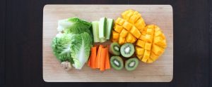 cut up fruit on a wooden cutting board