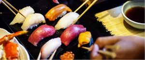 eating sushi with chopsticks