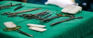 mixture of medical tools on a green medical mat