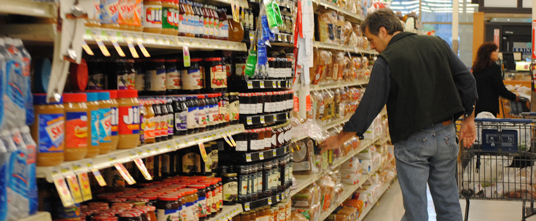 man shopping in a supermarket aisle
