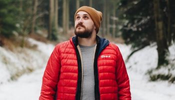a man with a beanie in a snowy forest