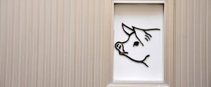 a pig drawn on a white wall