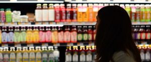 a woman shopping in the juice aisle