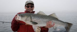 fisherman holding a large fish in his hands