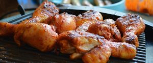 chicken being cooked on a grill