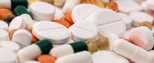 large mixture of different coloured and shaped pills
