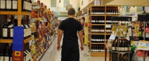 man walking down shopping aisle