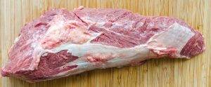 raw meat on a wooden cutting board