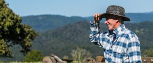 a farmer touching his hat