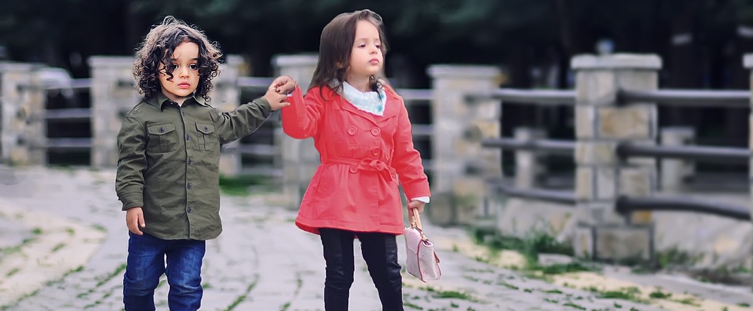 two fashionable children walking together