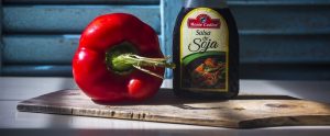 red pepper, salsa de soya on a wooden cutting board