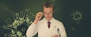 scientist standing in front of images of viruses