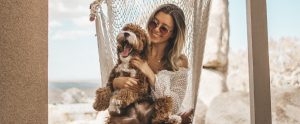a blonde woman with a dog on her lap