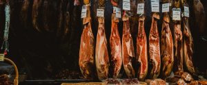 raw meat slabs hanging up