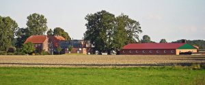 three farm buildings in the countryside