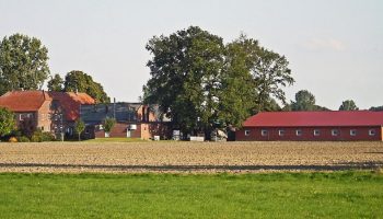 three farm buildings in the countryside
