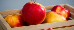 bright red apples in a box
