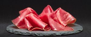meat on a black wooden surface