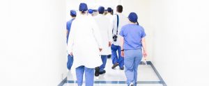 medical doctors walking down a white hallway