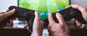 two people playing Fifa on a PlayStation 4