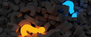 two illuminated question marks in a pile of gray question marks