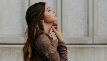 a woman looking up with her eyes closed