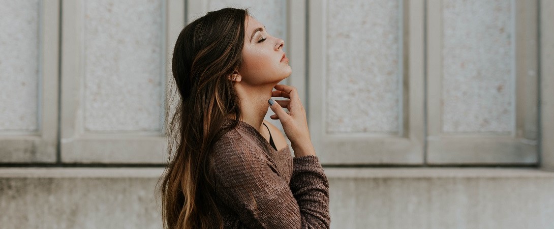 a woman looking up with her eyes closed