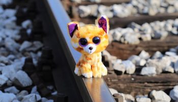 a toy cat on a railroad track