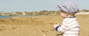 a preschooler playing on a sandy beach