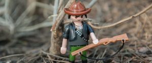 a miniature toy hunter with a shotgun