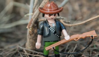 a miniature toy hunter with a shotgun