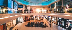 people walking through two floors of shopping malls