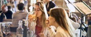 women in a fancy restaurant drinking and eating