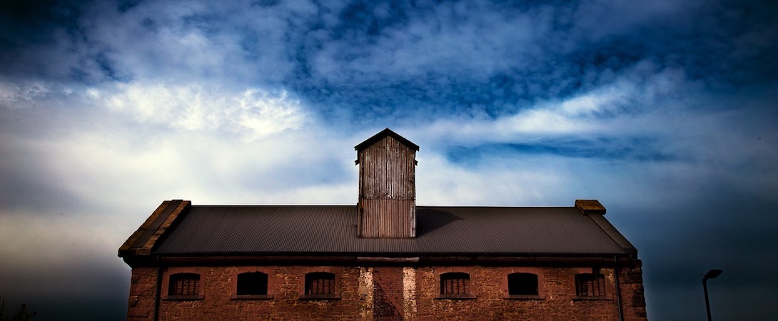 spooky warehouse in front of ominous weather