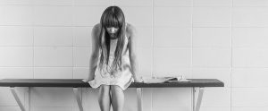 worried girl sitting on a bench