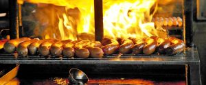 sausages being cooked near a fire