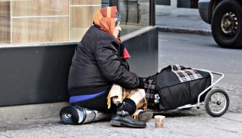 a homeless gypsy begging for money on the street