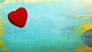 a red heart in front of a blue background
