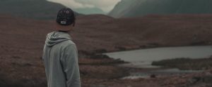 a man alone standing on a mountain
