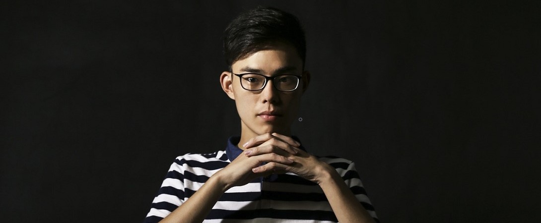 a Chinese man with his hands folded