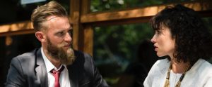bearded man talking to a woman