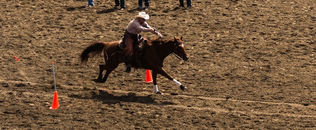 a man riding a race horse