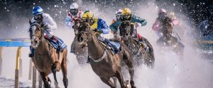professional horse racing in the winter snow by jockeys